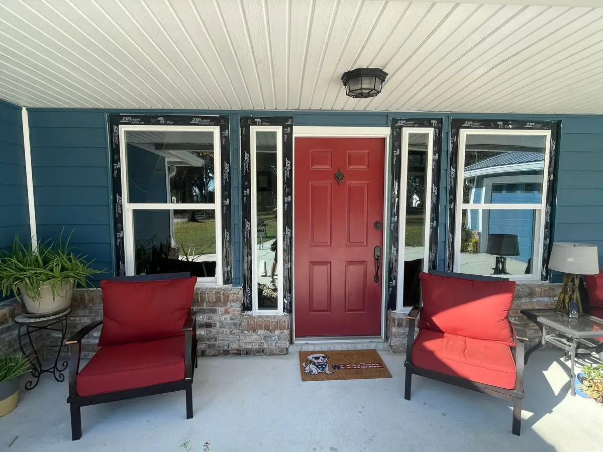 New white windows around a red front door