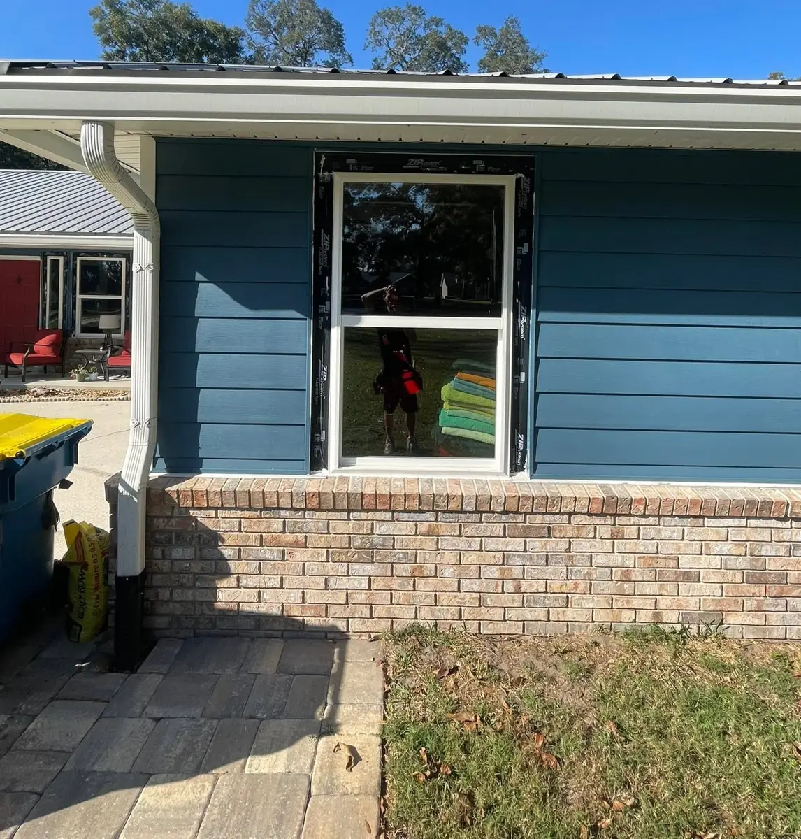 New window in blue siding